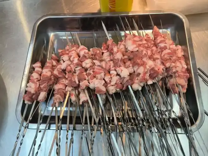 Grilled lamb leg over coals
